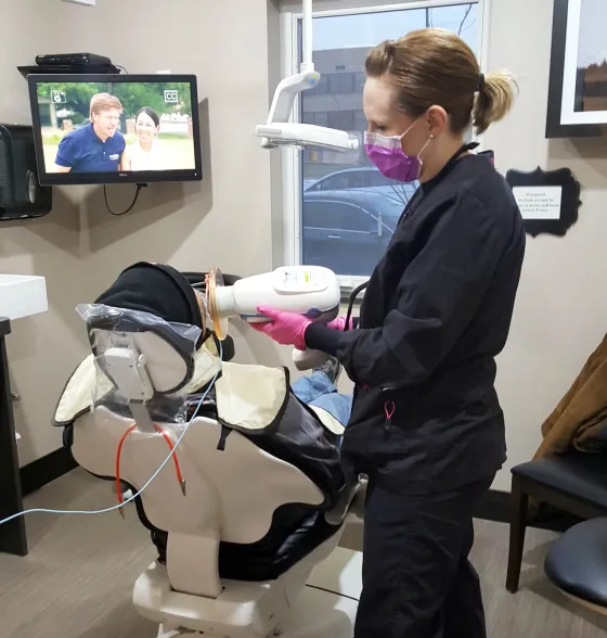 A clinician preparing a chairside unit in a treatment room.